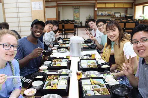 CET Japan study abroad students and local roommates enjoy lunch in a restaurant